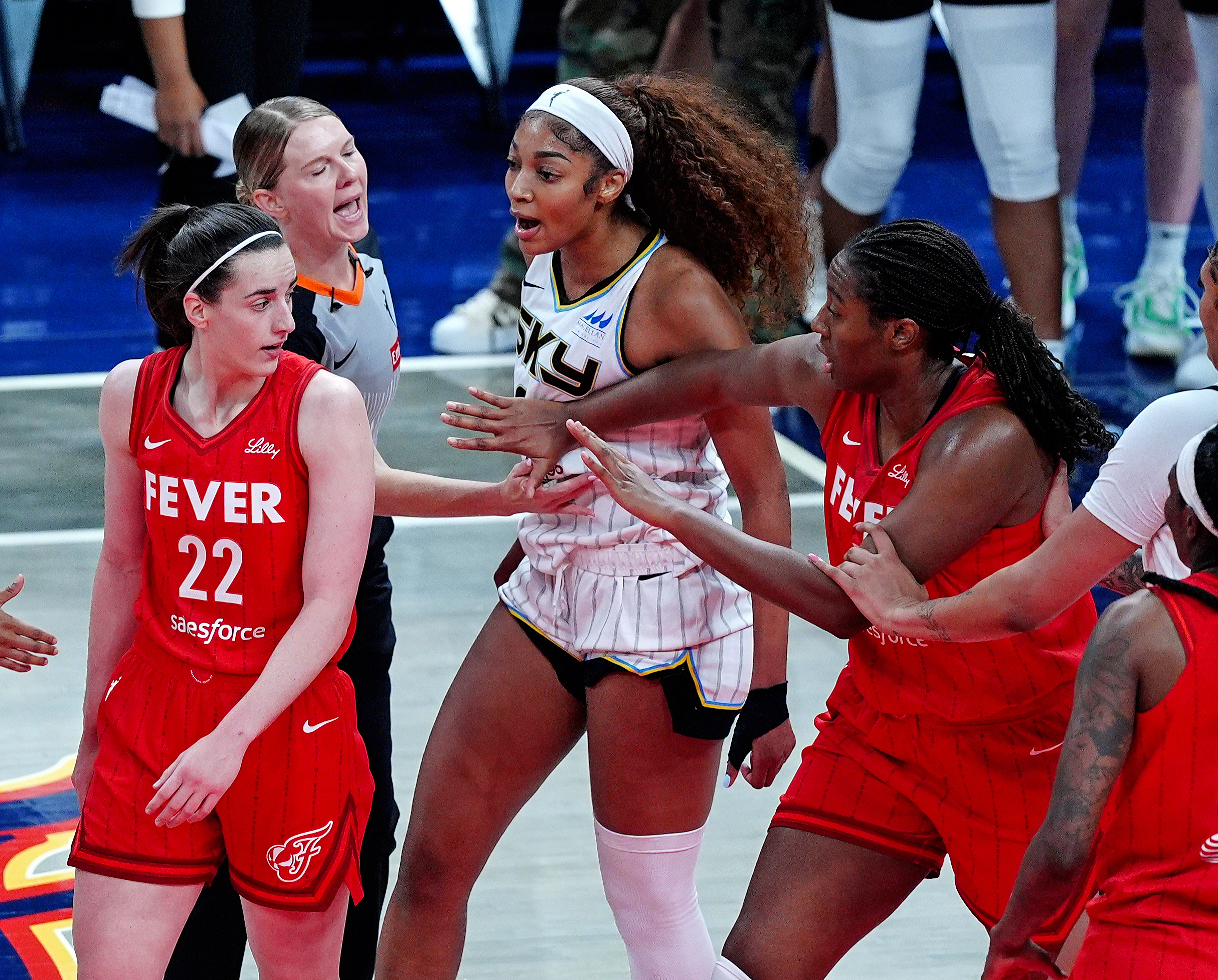 INDIANAPOLIS, IN – MAY 17: Chicago Sky forward Angel Reese (5) reacts after being fouled by Indiana Fever guard Caitlin Clark (22) as Indiana Fever forward Aliyah Boston (7) tries to separate Reese (5) from Clark (22) on May 17, 2025, at Gainbridge Fieldhouse in Indianapolis, Indiana. (Photo by Brian Spurlock/Icon Sportswire via Getty Images)