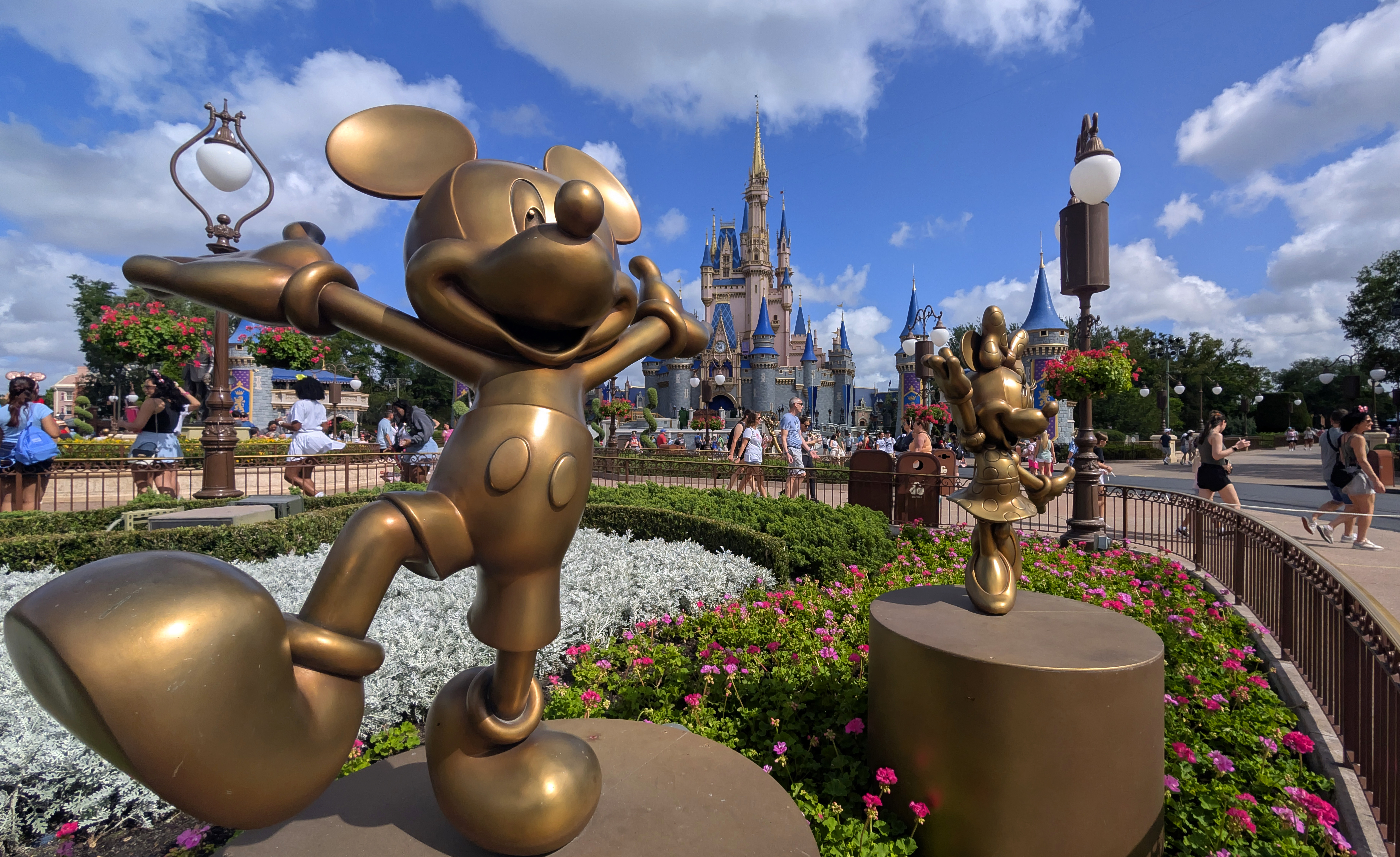 ORLANDO, FL – APRIL 3: Statues of Mickey Mouse and Minnie Mouse stand in a garden in front of Cinderella’s Castle at the Magic Kingdom Park at Walt Disney World on April 3, 2025, in Orlando, Florida. (Photo by Gary Hershorn/Getty Images)